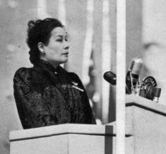  MADAME CHIANG, LOOKING TIRED BUT DETERMINED, SPEAKS FROM SPECIAL ROSTRUM 